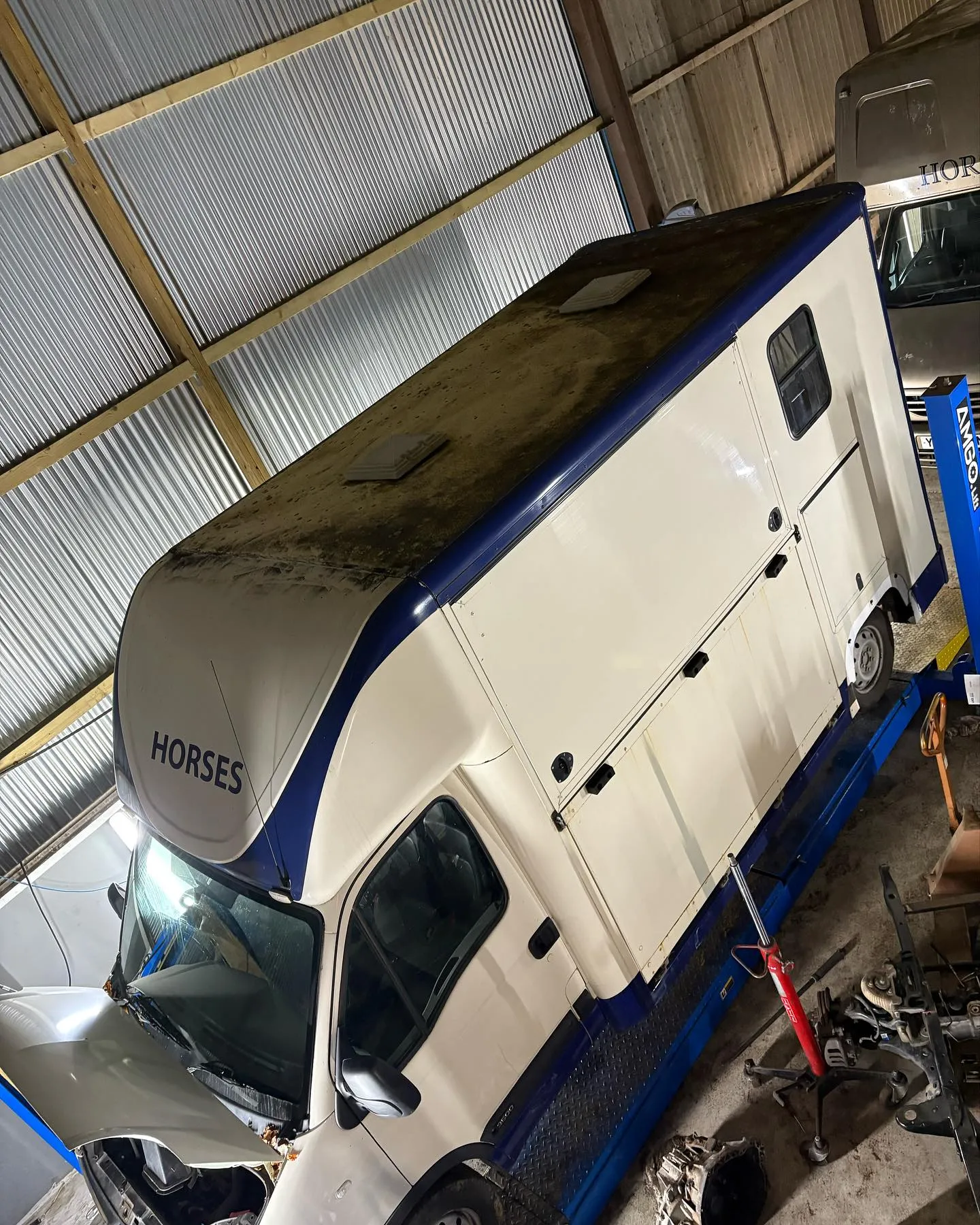 A white truck parked inside of a garage.