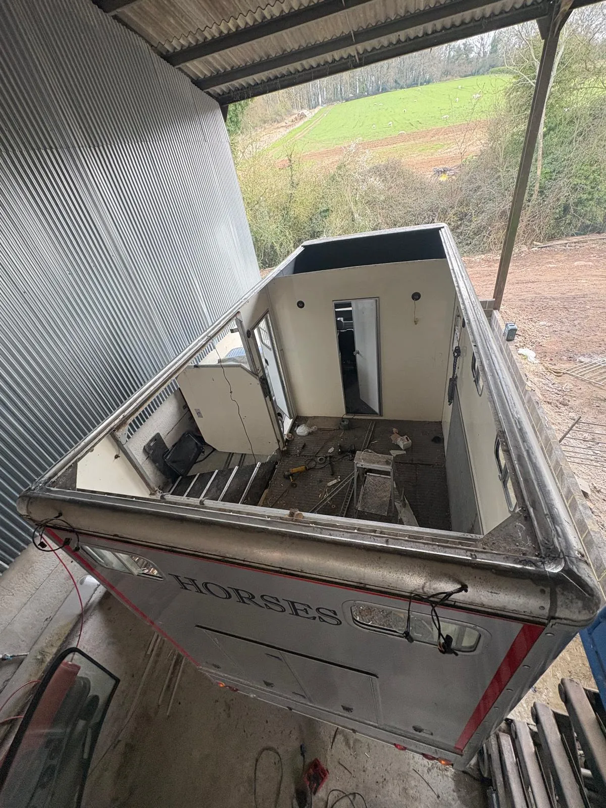 A boat sitting inside of a metal building.