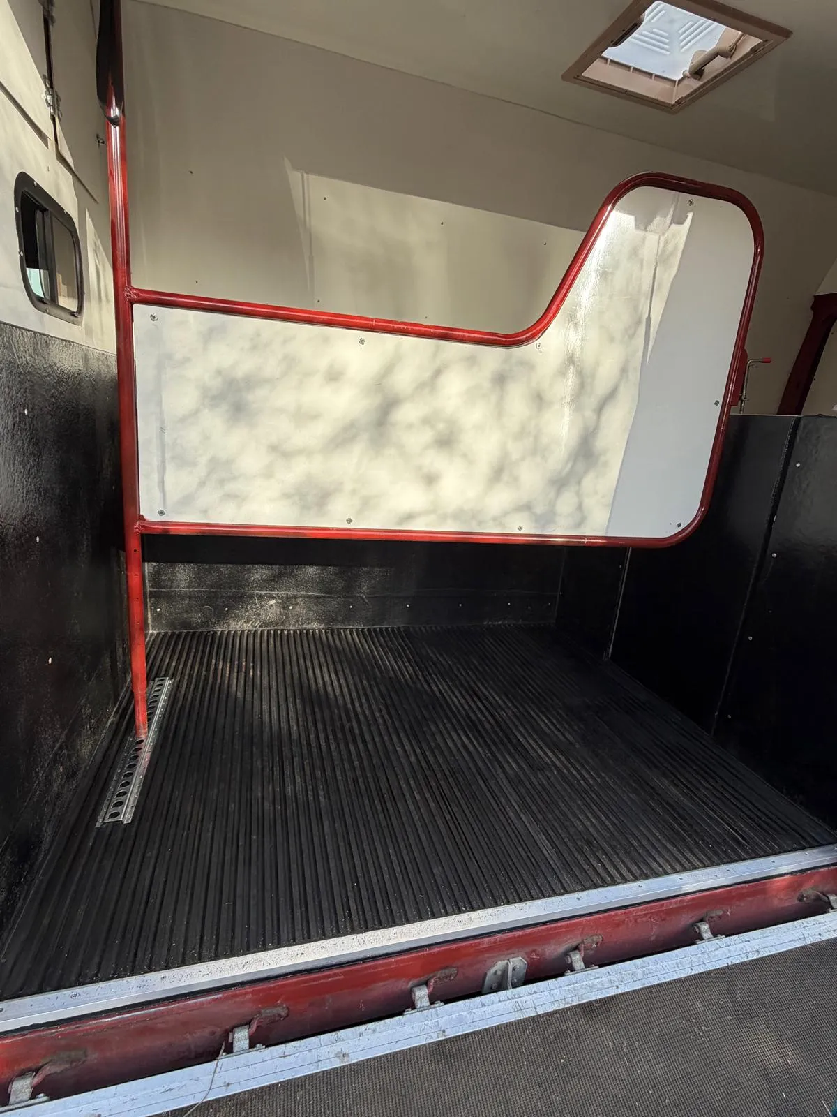The back of a truck with the door open.